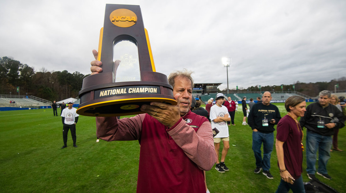 Florida State Mark Krikorian lifts the championship trophy